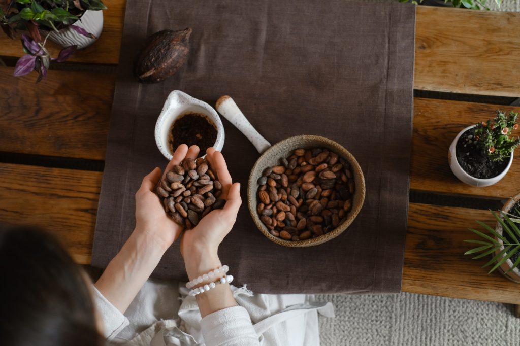 Woman hands holding organic cacao beans for ceremony
